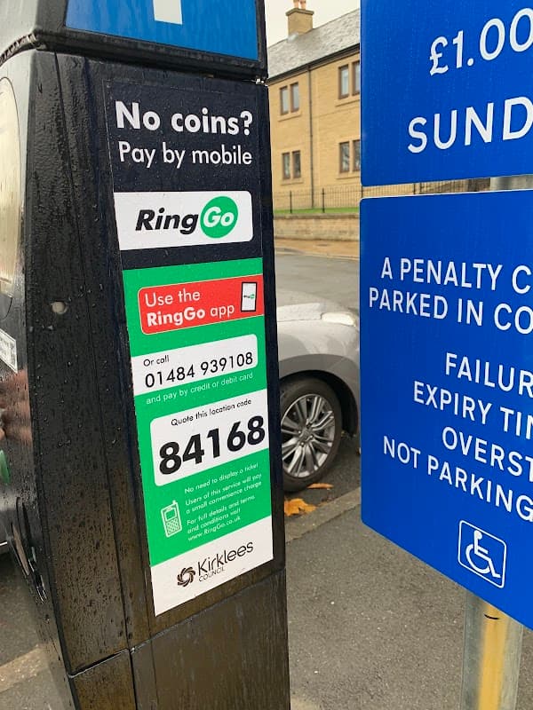 Parking payment station with RingGo instructions, a phone number, and a location code in Springwood Car Park, Huddersfield.