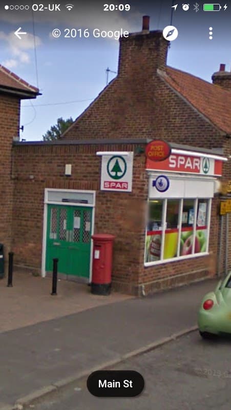 Spar shop with a red post box, green entrance, and large windows displaying products in Hutton Cranswick, Yorkshire.