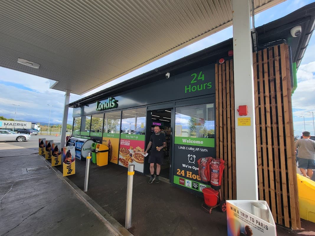 Exelby Services shop with a modern facade, open 24 hours, featuring food signage and a welcoming entrance.