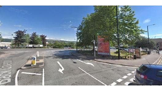 Car park entrance in Keighley, Yorkshire, with trees, signage, and clear blue skies in the background.