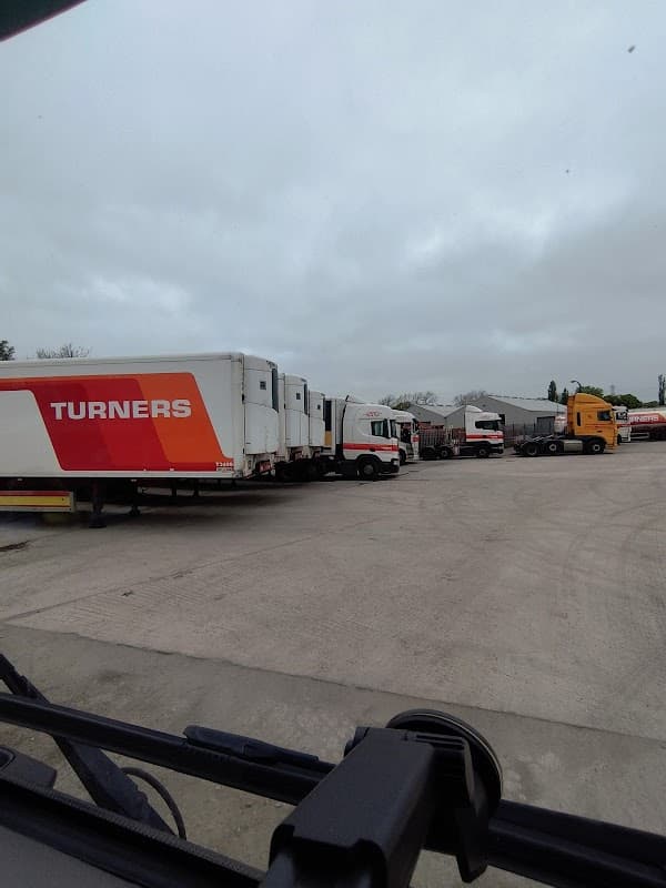 Trucks lined up in a car park with "Turners Ltd" branding, set against a cloudy sky in Ledston, Yorkshire.