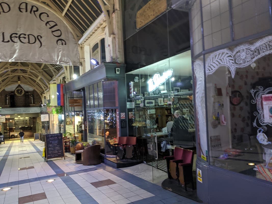 Grand Arcade in Leeds featuring shops, cafes, and decorative architecture with a bustling atmosphere.
