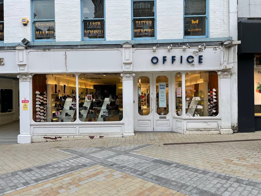 Shoe shop "OFFICE" on Briggate in Leeds, featuring a large window display with various footwear styles.