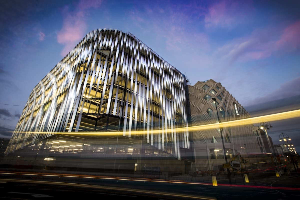 Modern multi-storey car park with illuminated facade, set against a twilight sky in Leeds, Yorkshire.