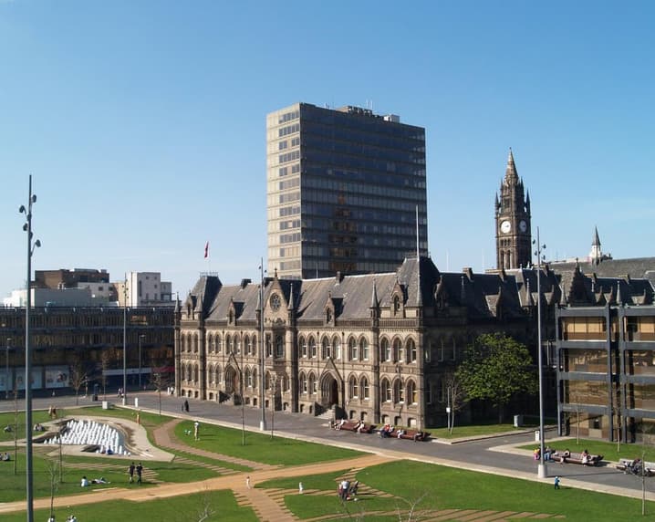 Centre Square features a mix of modern and historic architecture, with green spaces and a clock tower in the background.