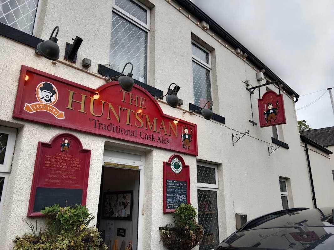 Traditional pub exterior with red signage, lanterns, and a welcoming entrance in Millhouse Green, Yorkshire.
