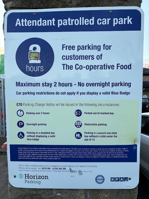 Sign for COOP Car Park in Mirfield, Yorkshire, detailing parking rules, charges, and conditions for Blue Badge holders.