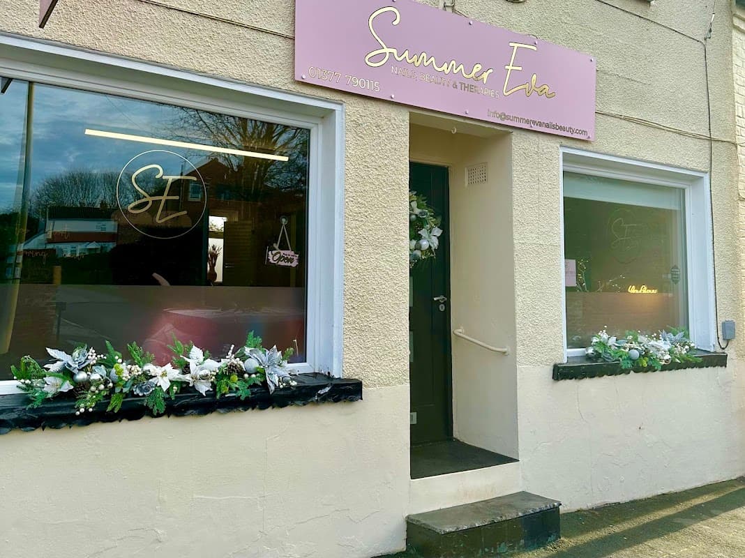 Exterior of Summer Eva salon in Nafferton, Yorkshire, featuring floral decorations and a pink sign above the entrance.