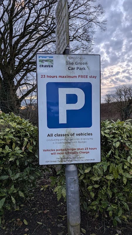 Sign for The Green Car Park with a blue 'P' symbol, stating free parking for 23 hours in Nappa, North Yorkshire.