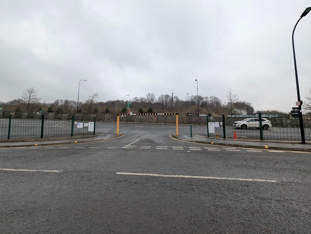 Pay & Display car park entrance in Neepsend, Yorkshire, with barriers, signage, and a white car in the background.