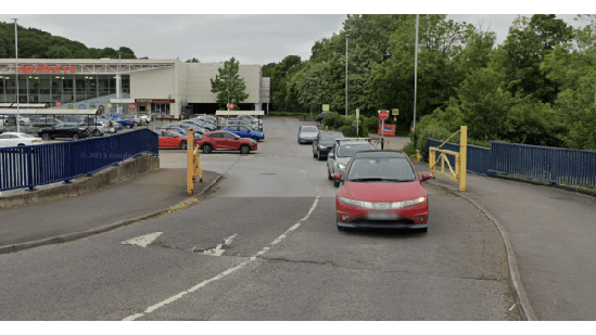 Pay & Display parking area in Nether Edge, Yorkshire, with cars and greenery in the background.