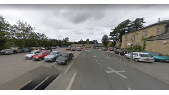 Pay & Display parking area in Norristhorpe, Yorkshire, with various parked cars and a cloudy sky.