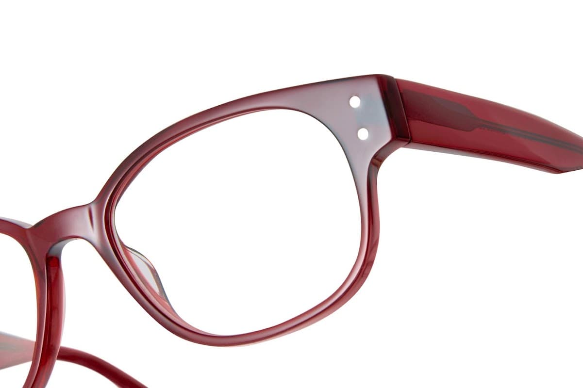 Red eyeglasses with a stylish frame, showcasing a modern design and clear lenses.