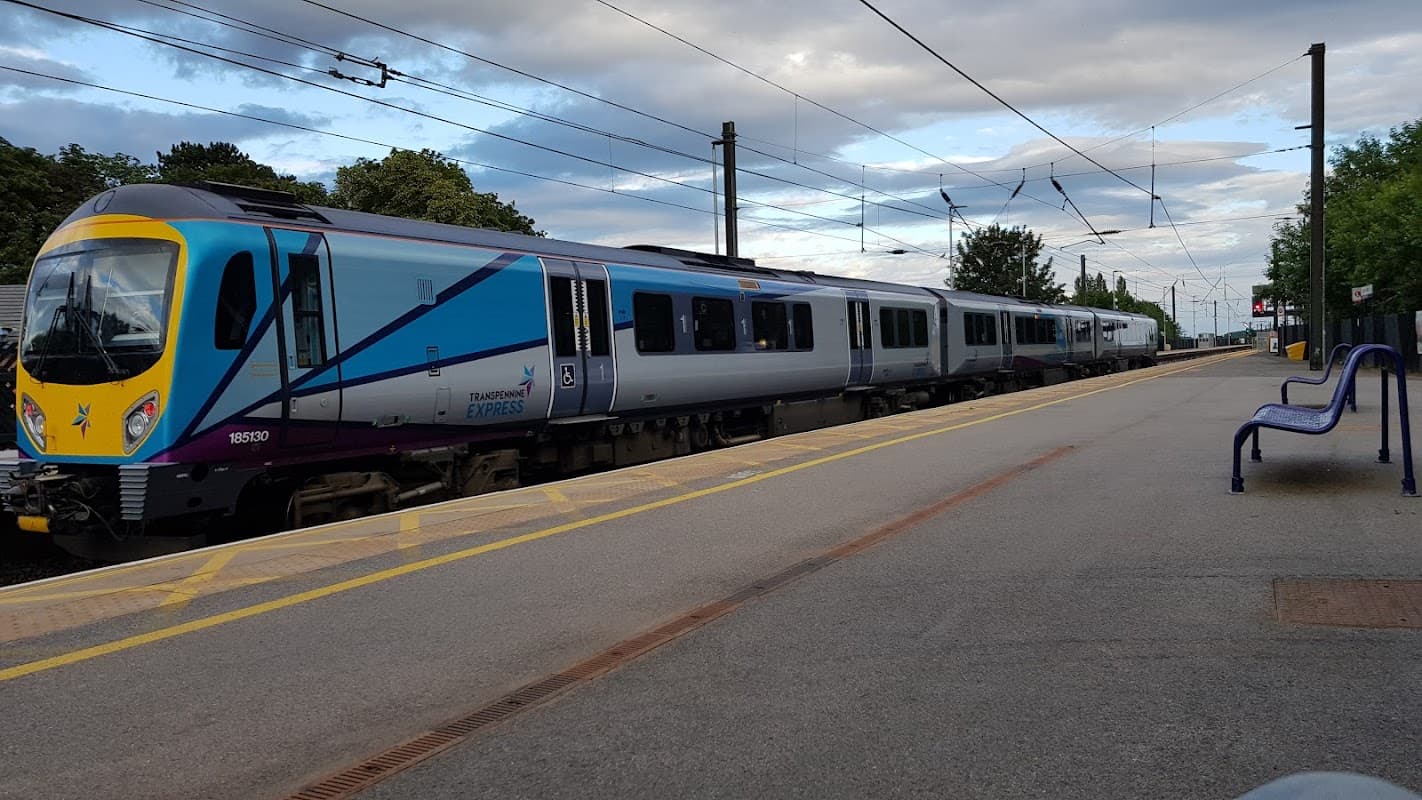 Northallerton Railway Station features a train at the platform, with benches and overhead wires visible.
