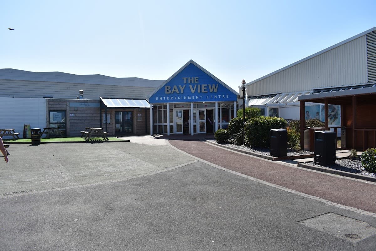 The Bay View Entertainment Centre entrance at Haven Holiday Park, with a clear sky and landscaped pathways.