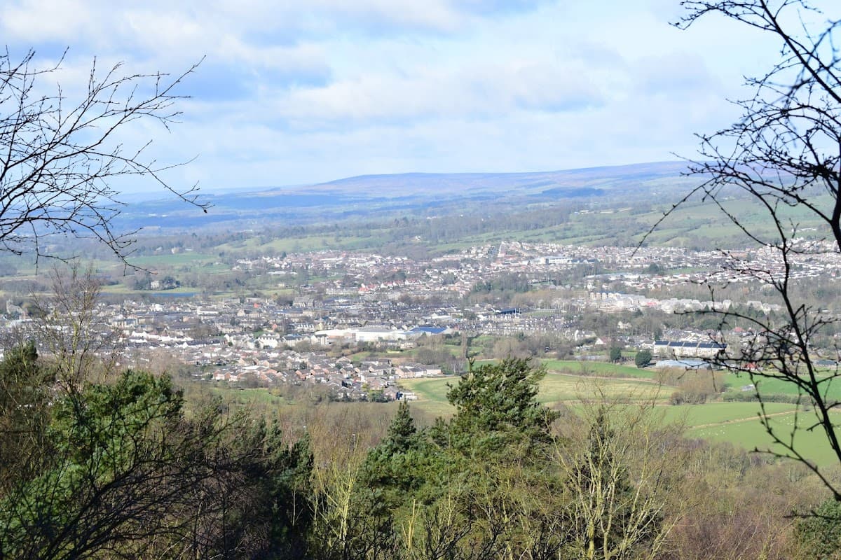 A panoramic view of Otley and surrounding greenery from Lower Shawfield Car Park, with rolling hills in the background.