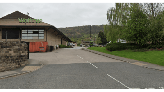 Pay & Display parking area near Waitrose, with trees and hills in the background, in Otley, Yorkshire.