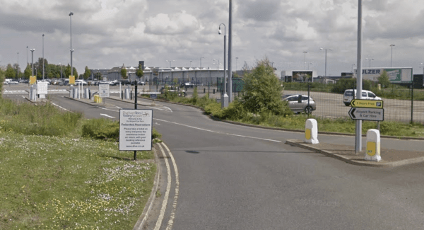 Pay & Display parking area in Over Dinsdale, Yorkshire, with signage and vehicles in a spacious lot.