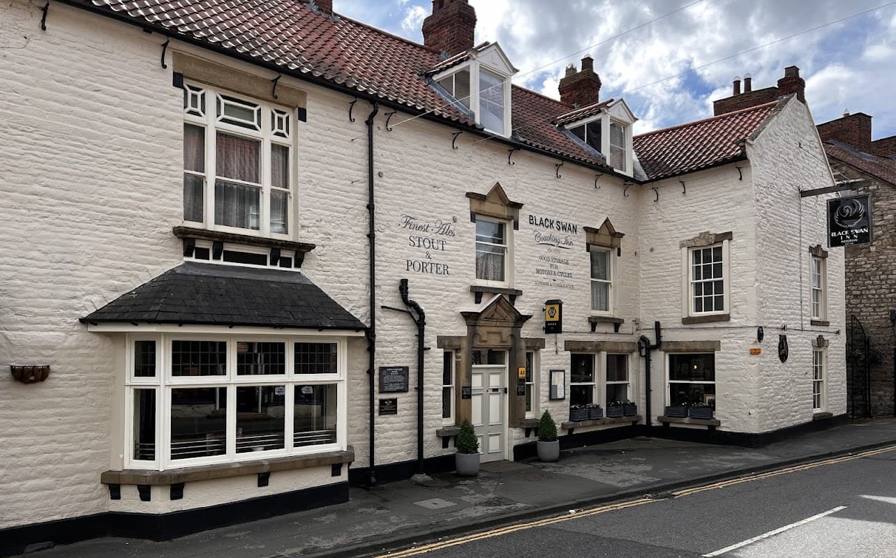 Charming white-washed building with a red tiled roof, featuring large windows and a welcoming entrance in Pickering.