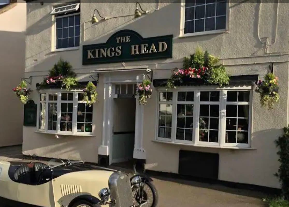The Kings Head restaurant with flower baskets, large windows, and a vintage car parked outside in Pollington, Yorkshire.