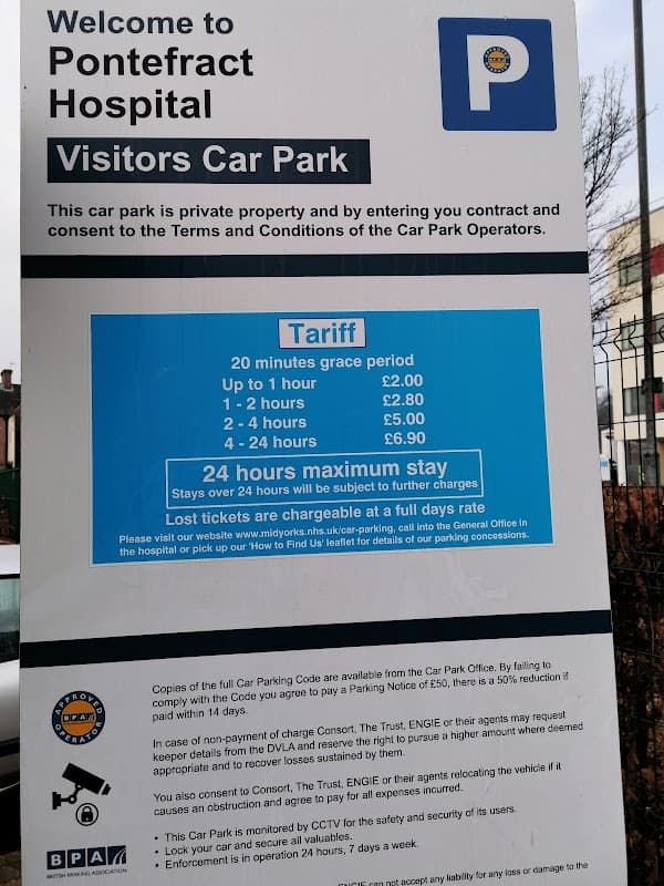 Sign for Pontefract Hospital's Visitors Car Park with tariff details and payment instructions. Pay & Display notice included.