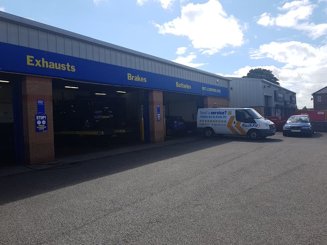 Kwik Fit garage in Redcar, featuring service bays, vehicles, and signage for exhausts, brakes, and batteries.