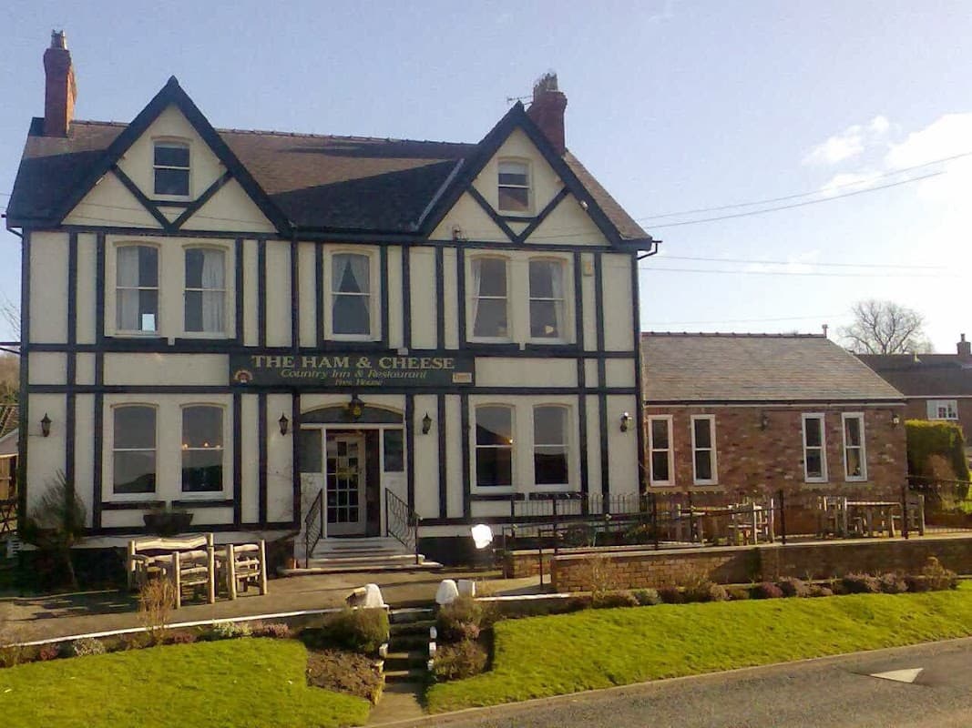 Victorian-style restaurant with black and white facade, large windows, and outdoor seating in Scagglethorpe, Yorkshire.