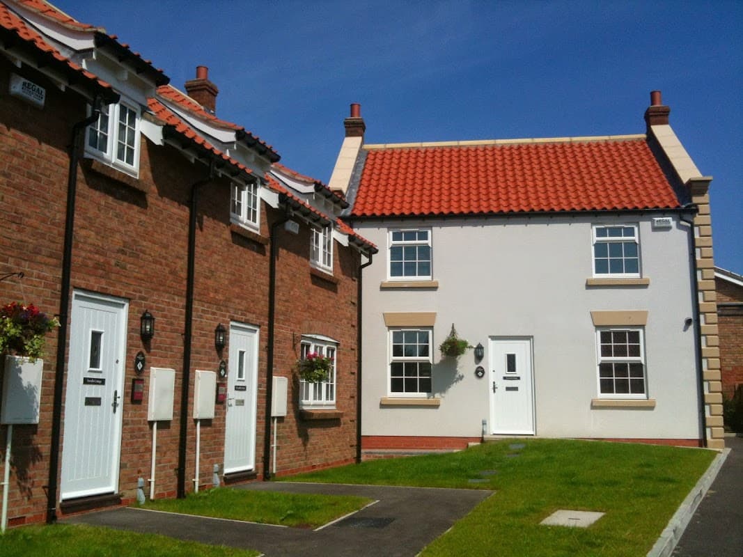 Charming Bed & Breakfast with red-tiled roofs, white and brick facades, and green lawns in Seamer, Scarborough.