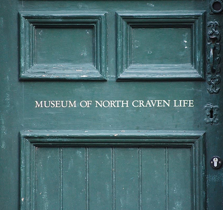 Green door with the text "MUSEUM OF NORTH CRAVEN LIFE" prominently displayed in white lettering.