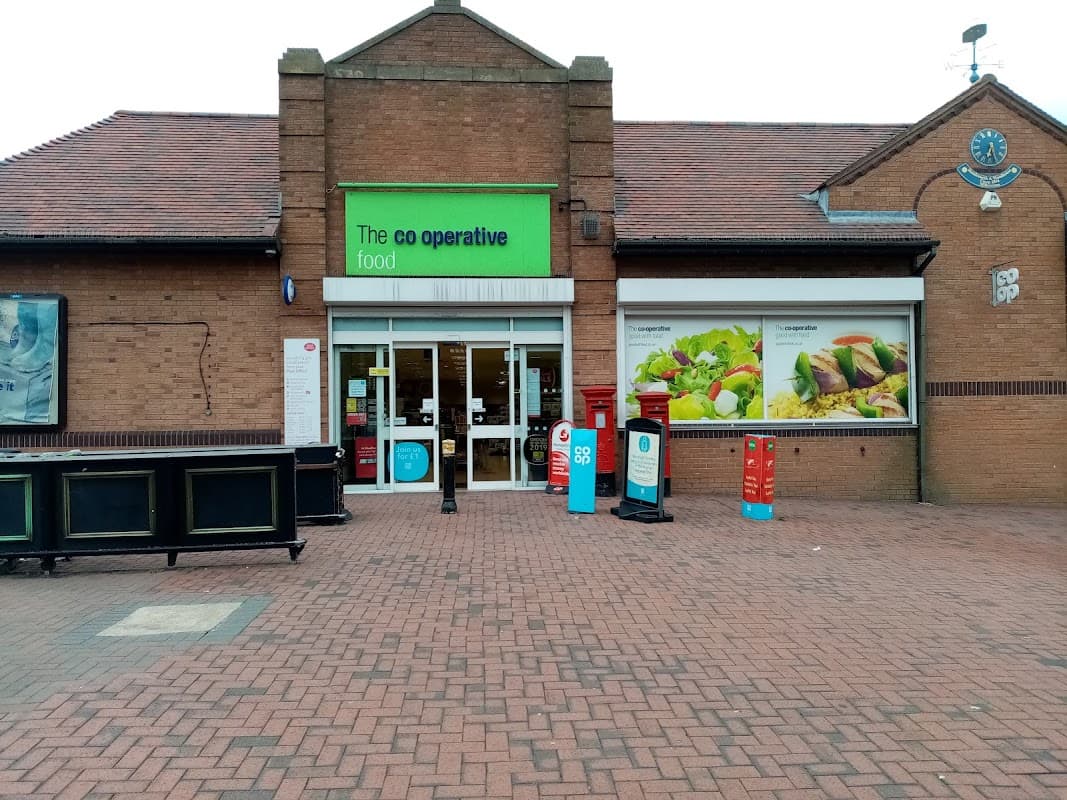 Co-op Food storefront with large windows, colorful signage, and outdoor seating area in Sheffield, Yorkshire.