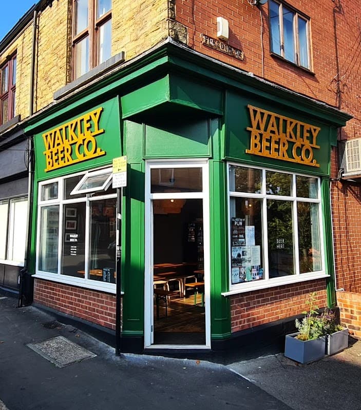 Green storefront of Walkley Beer Co. with large yellow signage, featuring windows and a welcoming entrance.