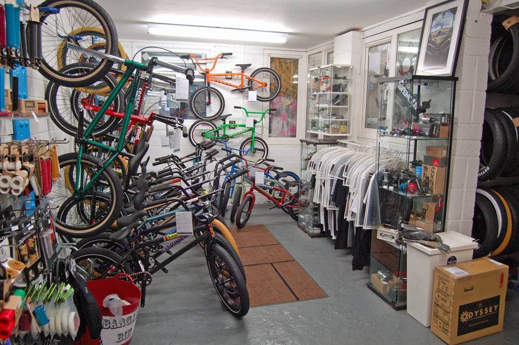 BMX bikes and apparel displayed in a bright shop, with shelves of bike parts and accessories in Sheffield.