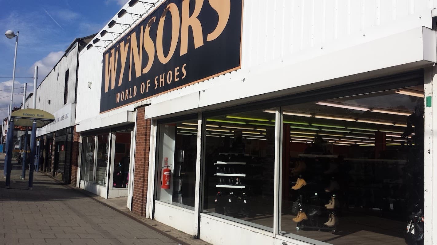 Wynsors shoe shop exterior in Sheffield, featuring large windows showcasing footwear and a bright sign above.
