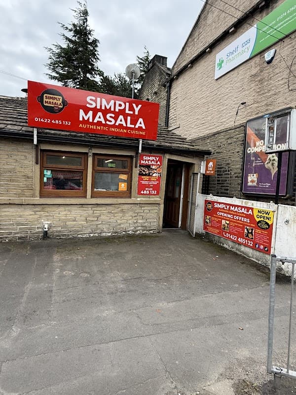 Bright red signage for "Simply Masala" restaurant, featuring windows and a door, with nearby pharmacy signage.