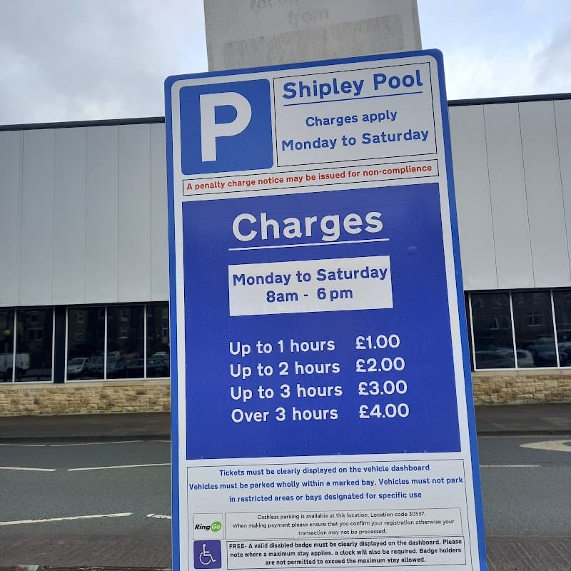Sign at Shipley Pool Car Park detailing parking charges and hours of operation, with clear pricing for different time durations.