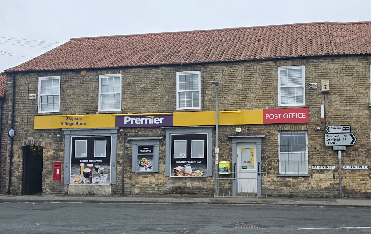 Premier Village Store with yellow signage, Post Office, and food displays, set in a brick building in Skipsea, Yorkshire.