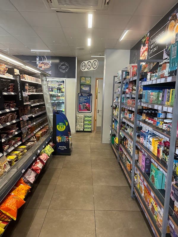 Interior of M&S Food To Go in South Milford, featuring shelves of snacks, drinks, and ready-to-eat meals.