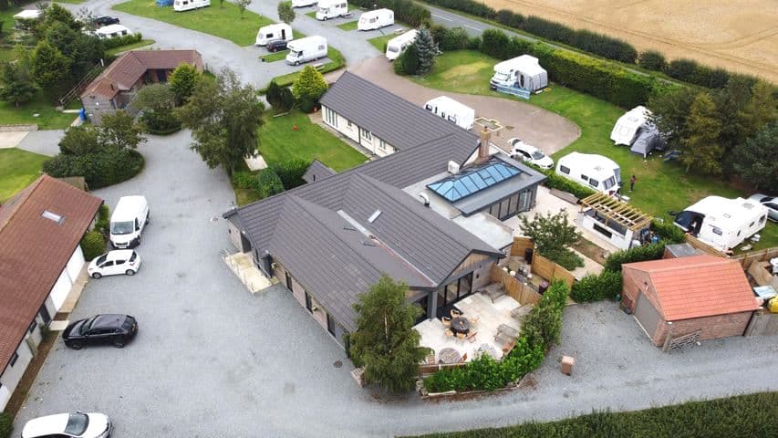 Aerial view of Spring Valley Campsite featuring cottages, caravans, and landscaped grounds in Sproatley, Yorkshire.