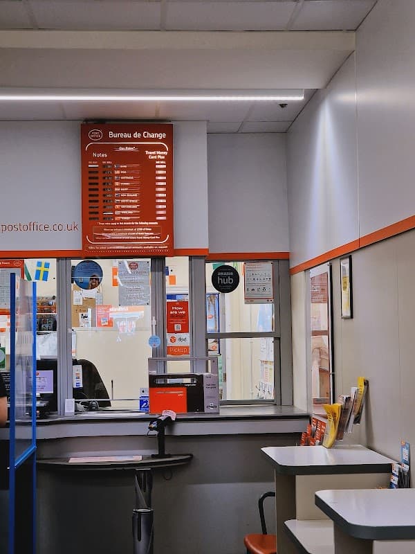 Interior of Thirsk Post Office featuring a service counter, notice boards, and a bureau de change display.