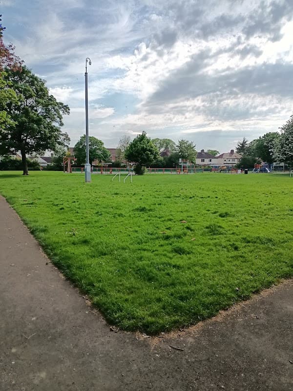 Green grassy area with trees, playground equipment in the background, and a cloudy sky over Thornaby, Yorkshire.