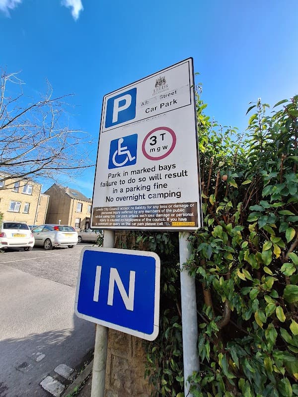 Sign for Albion Street Car Park in Tingley, Yorkshire, displaying parking rules and free parking information.