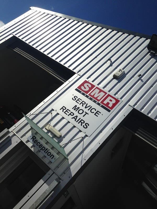 Sign for SMR Garage in Tockwith, Yorkshire, displaying services: 'Service', MOT, Repairs, with a reception area visible.