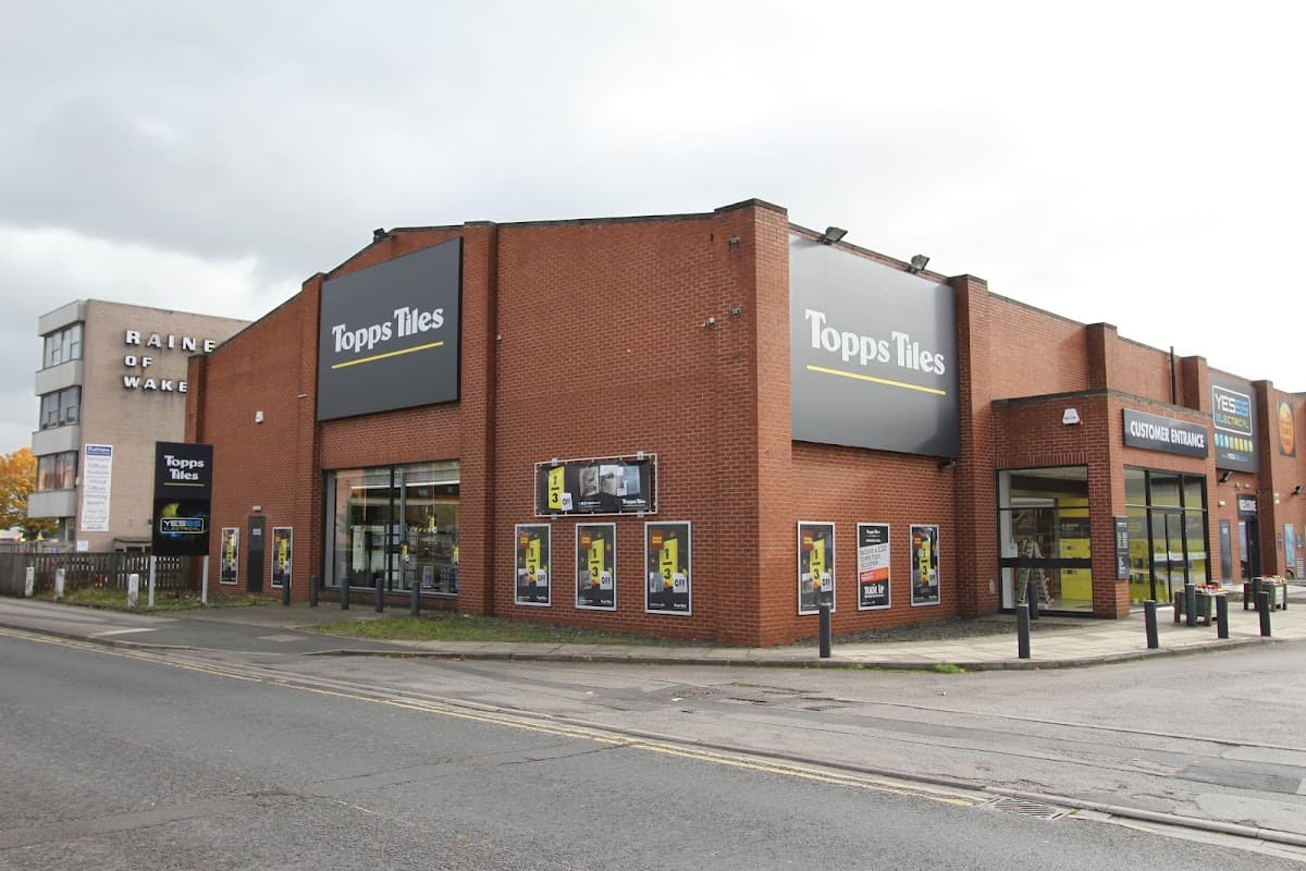 Topps Tiles store in Wakefield, featuring large signage and a modern storefront with display windows.