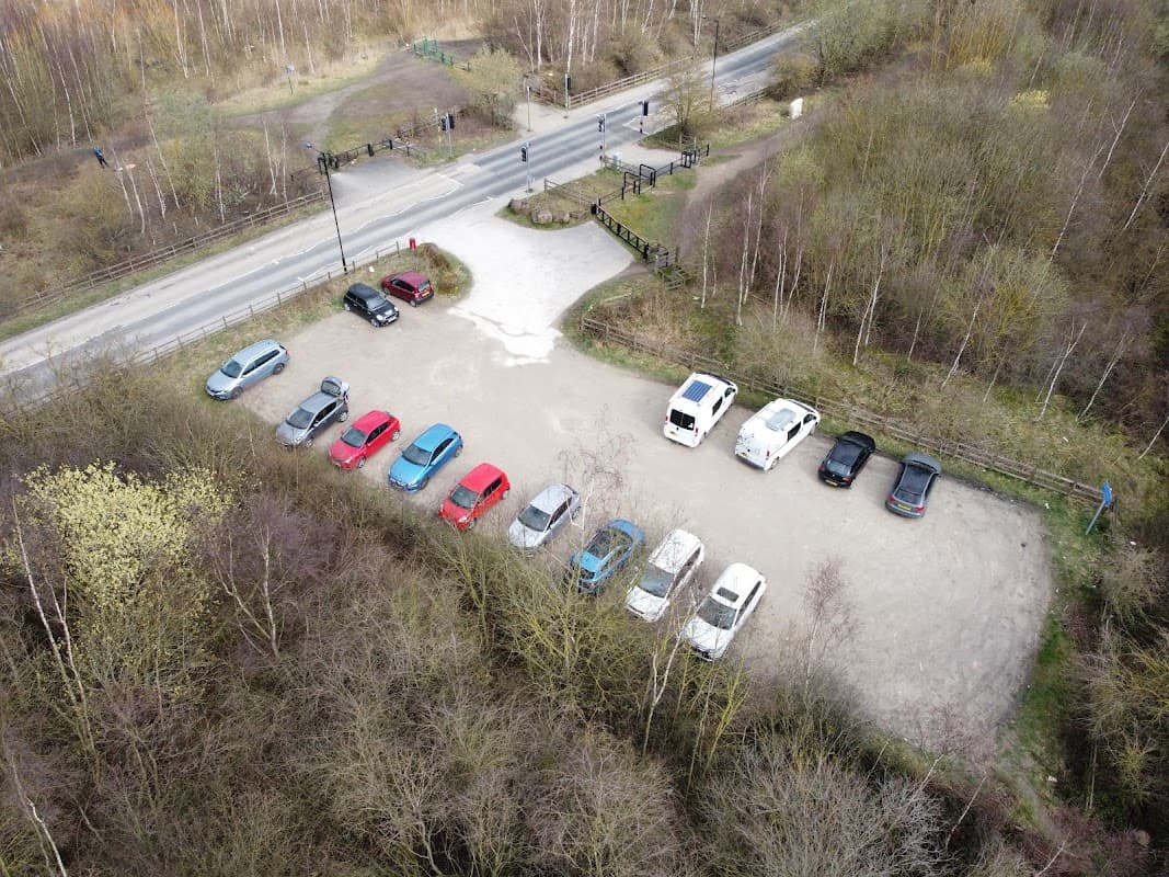 Aerial view of a car park with various parked cars surrounded by trees and a road in Wath upon Dearne, Yorkshire.
