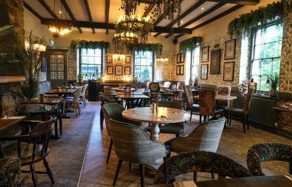 Cozy bar interior with wooden beams, floral decor, vintage furniture, and warm lighting in Wentworth, Yorkshire.