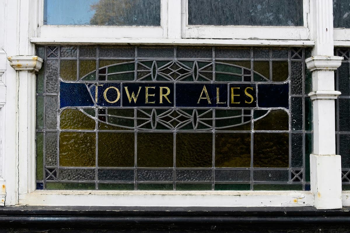 Stained glass window displaying "Vower Ales" with decorative patterns in a shopping centre.