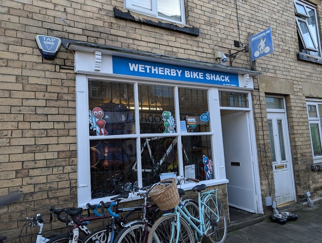 Wetherby Bike Shack storefront with colorful cartoon characters, bicycles parked outside, and a blue sign above.