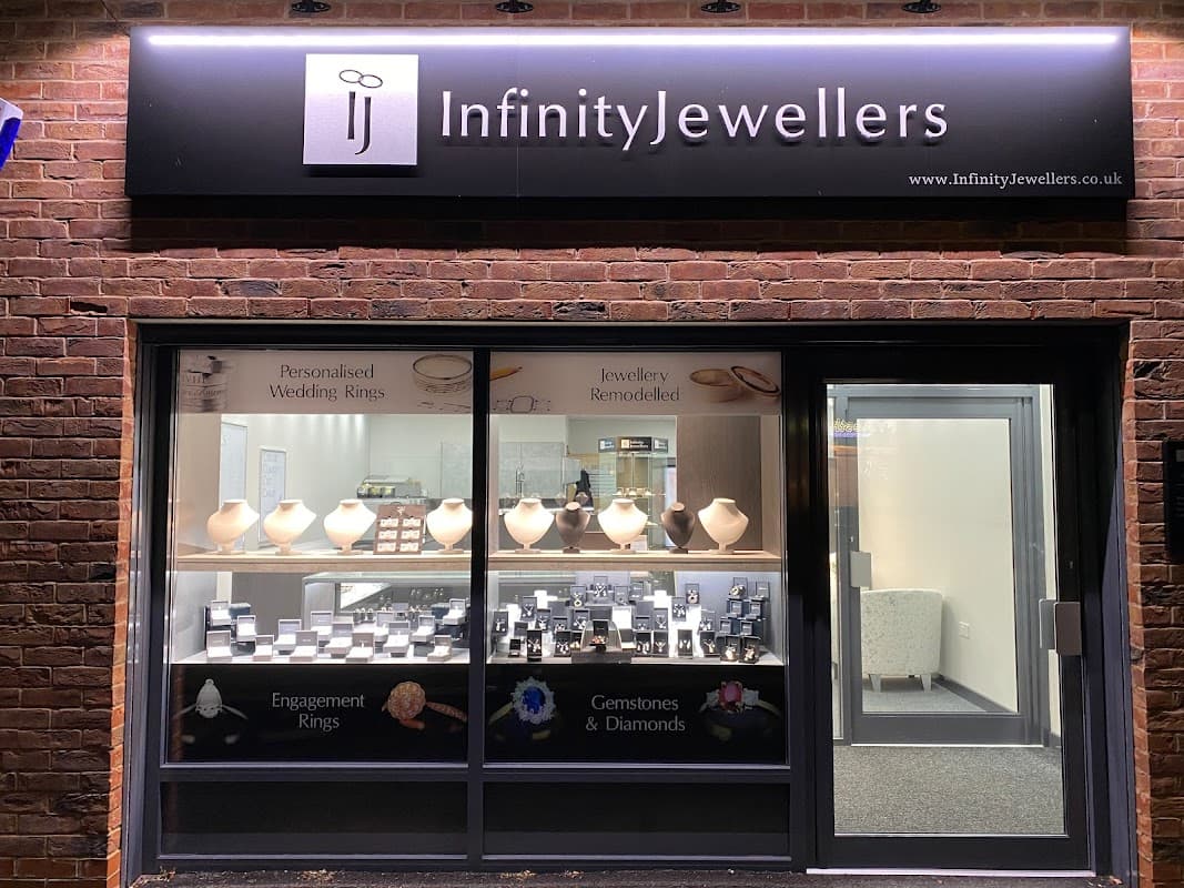 Shopfront of Infinity Jewellers displaying jewelry, including rings and gemstones, with a modern, inviting design.