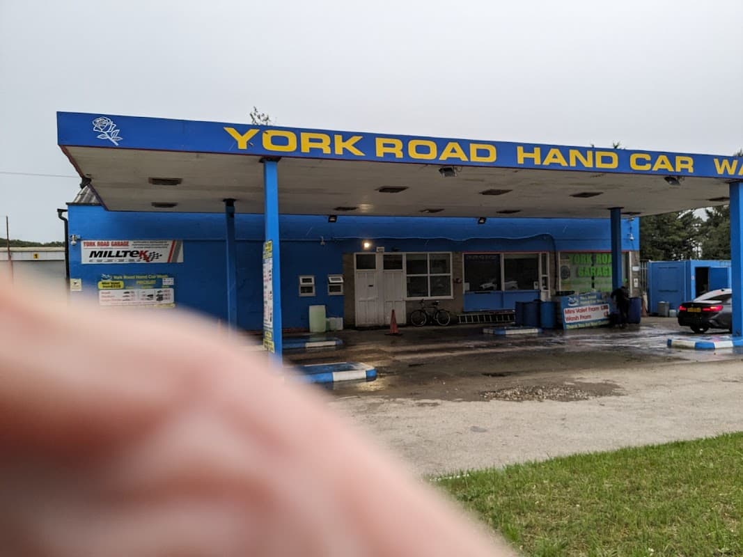 York Road Garage with blue exterior, signage, and a car wash area, located in Wilberfoss, Yorkshire.