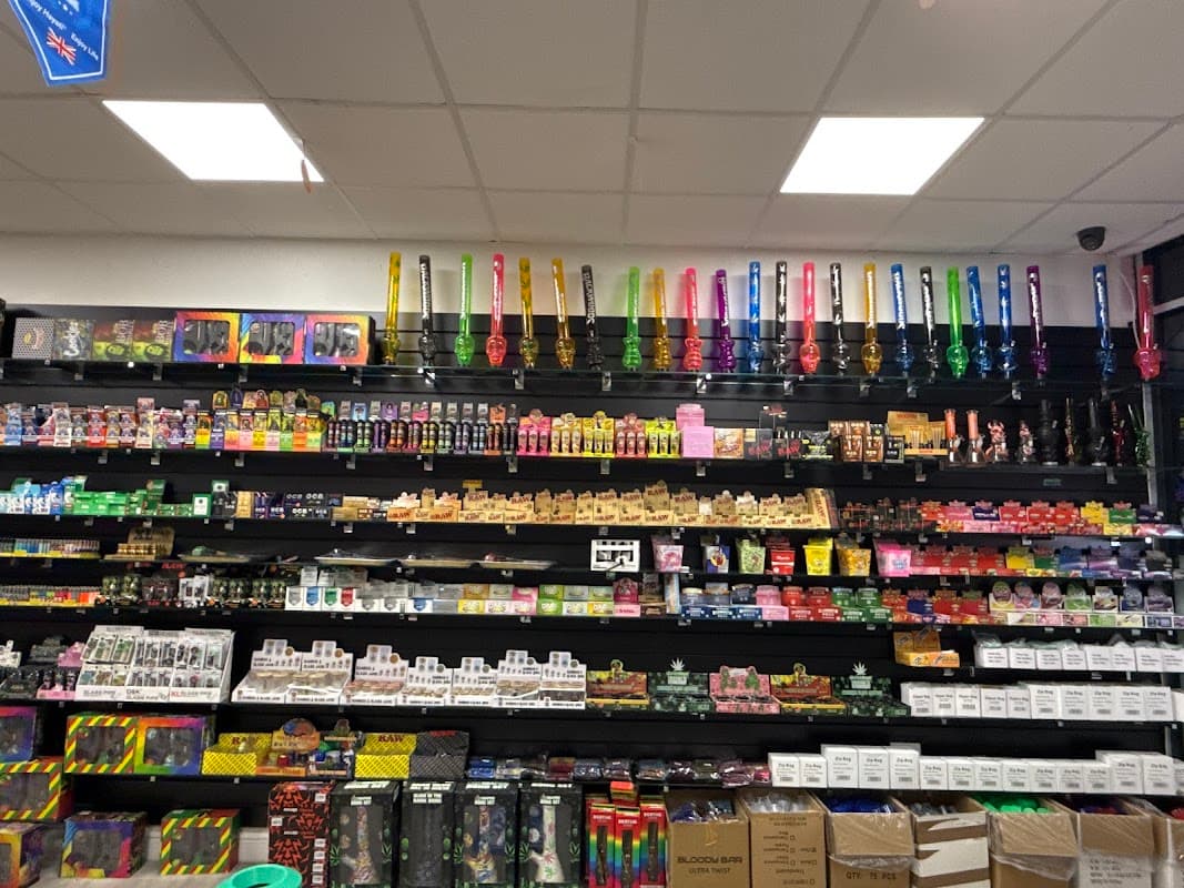 Colorful vape products and accessories displayed on shelves at SMOKE & VAPE Wombwell in Yorkshire.